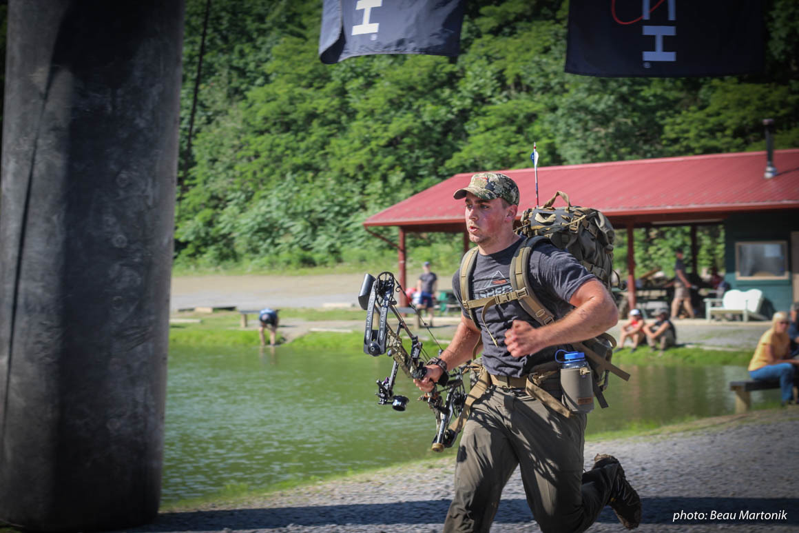 Man running with pack and bow in Hike to Hunt fitness competition. Man running with pack and bow in Hike to Hunt fitness competition.