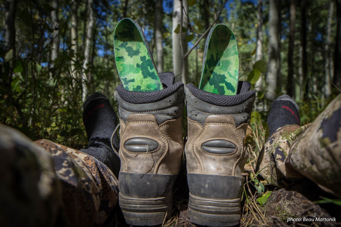 Hunting boots with insoles drying while hunting in the mountains. Hunting boots with insoles drying while hunting in the mountains.
