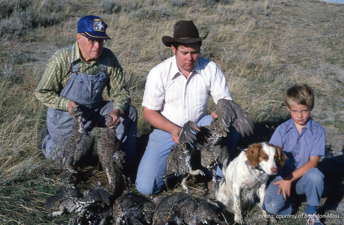 Three generations of Montana hunters with Brittany spaniel and sage grouse, upland hunting. Three generations of Montana hunters with Brittany spaniel and sage grouse, upland hunting.