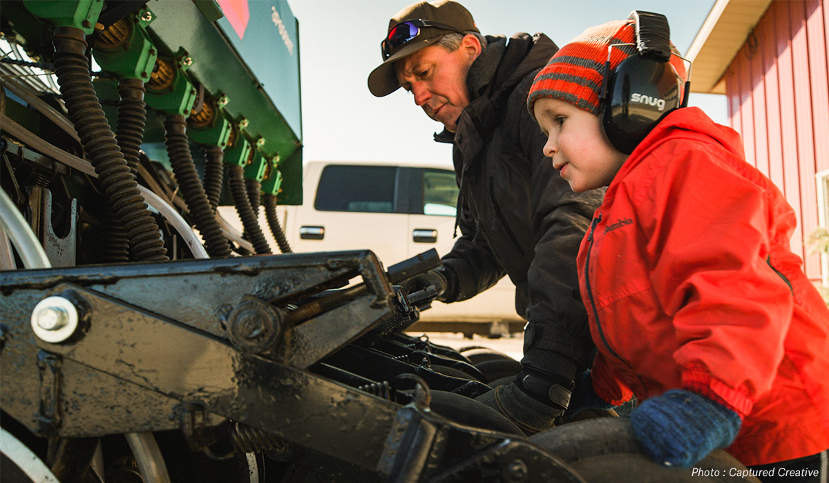 Taylor Kollman's father and son inspecting equipment on their Minnesota hunting property. Taylor Kollman's father and son inspecting equipment on their Minnesota hunting property.