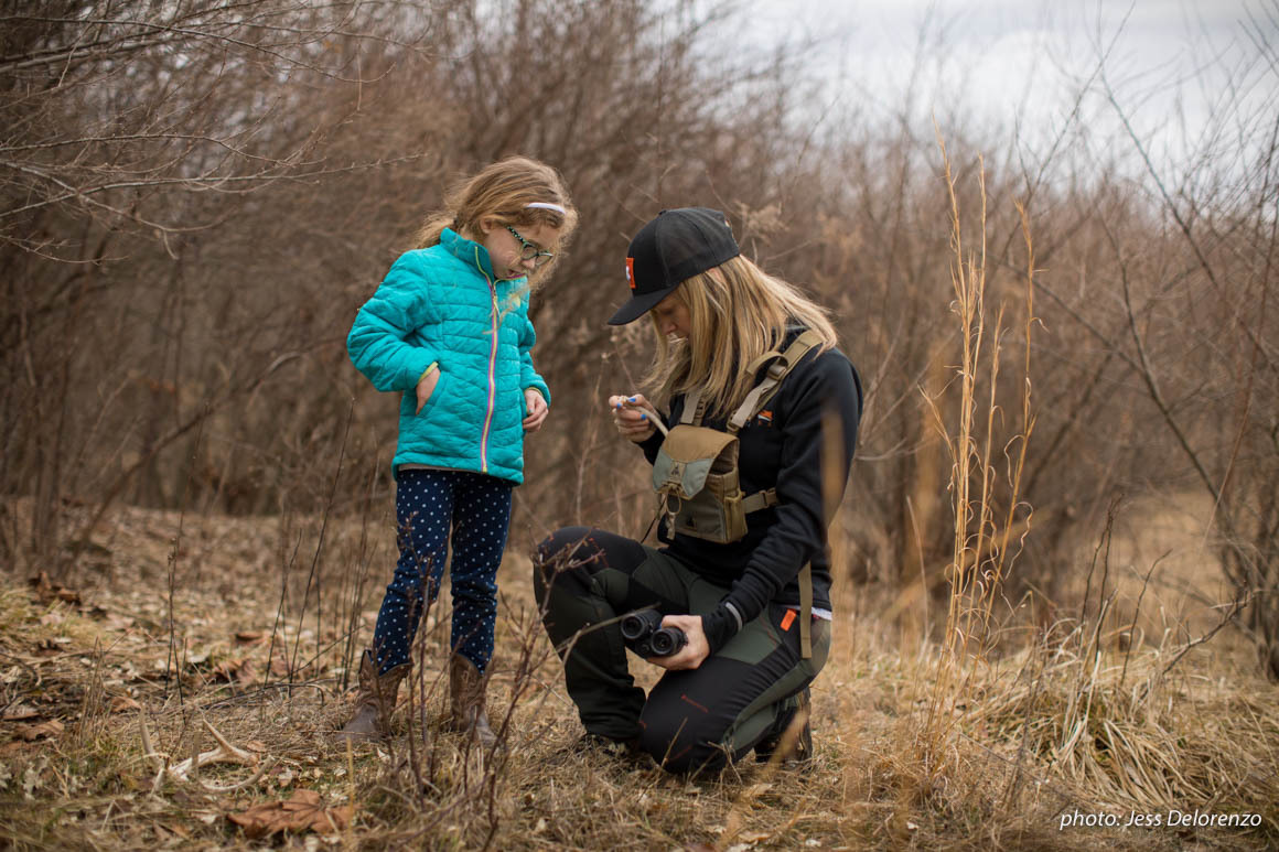 Woman and girl in woods looking at shed antlers. Woman and girl in woods looking at shed antlers.