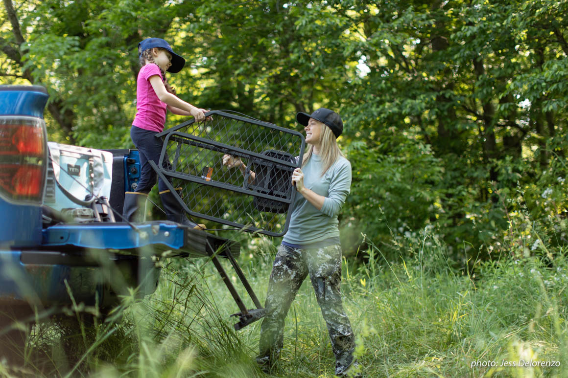 Mother and daughter setting up a treestand in Pennsylvania for hunting. Mother and daughter setting up a treestand in Pennsylvania for hunting.