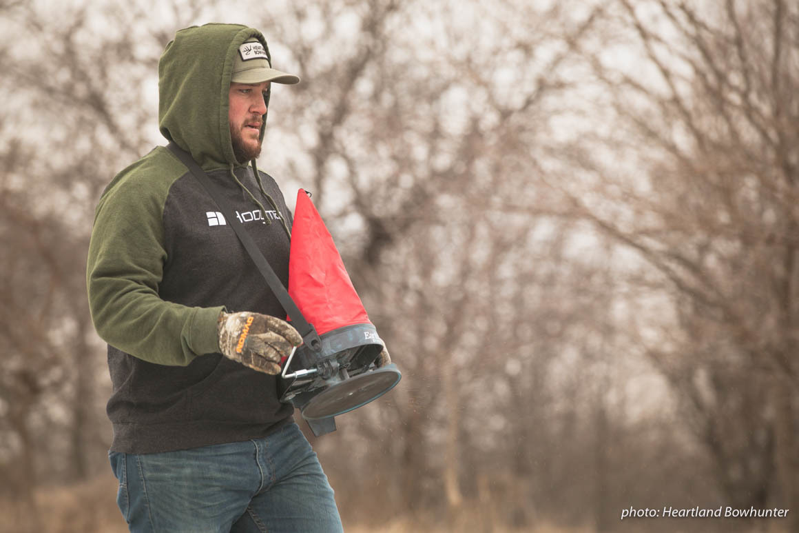 Man walking and distributing seed in a field in the winter. Man walking and distributing seed in a field in the winter.