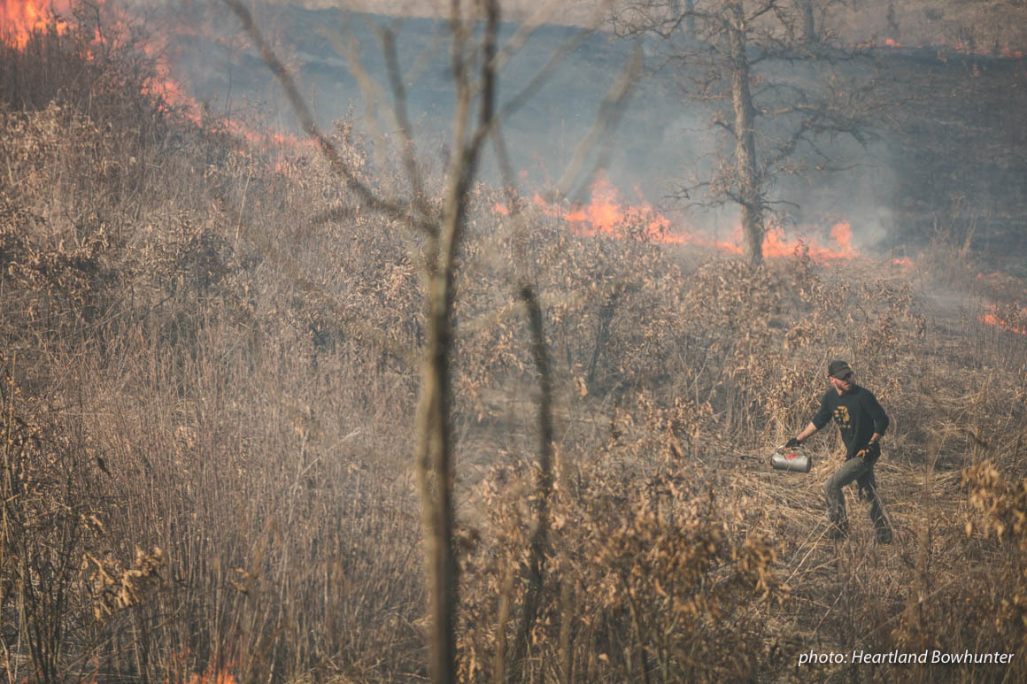 Man in field doing controlled burn to halp manage land for hunting. Man in field doing controlled burn to halp manage land for hunting.