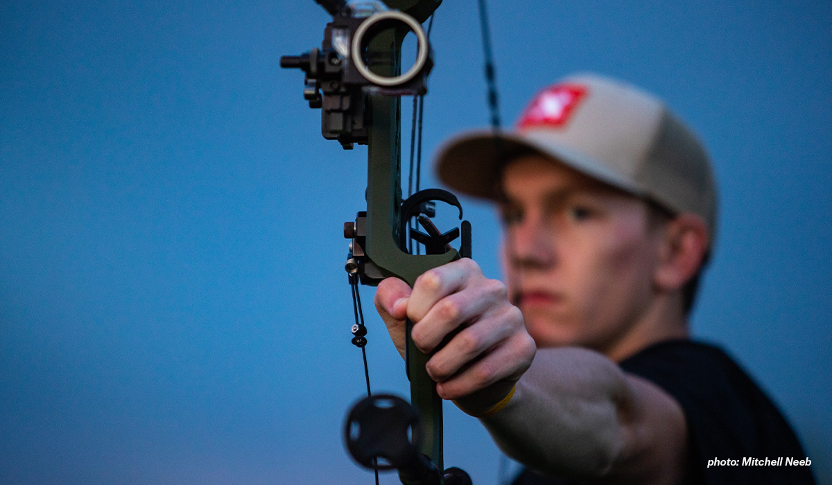 Man shooting compound bow. Man shooting compound bow.