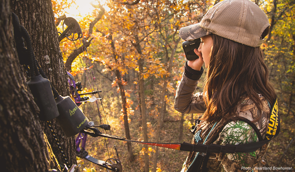 Woman in tree stand bow hunting. Woman in tree stand bow hunting.