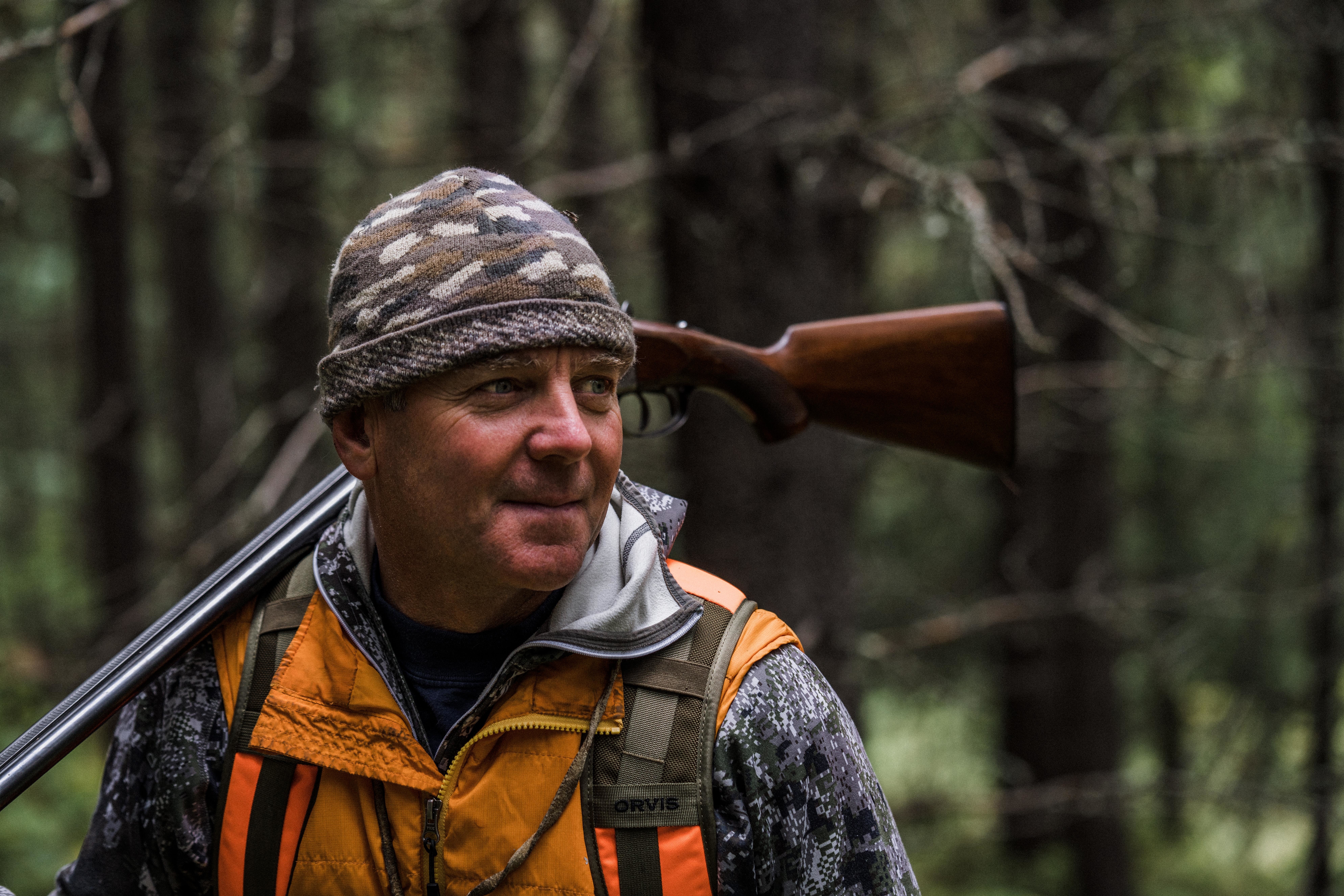 Montana outfitter Tim Linehan carries a shotgun while grouse hunting. Montana outfitter Tim Linehan carries a shotgun while grouse hunting.
