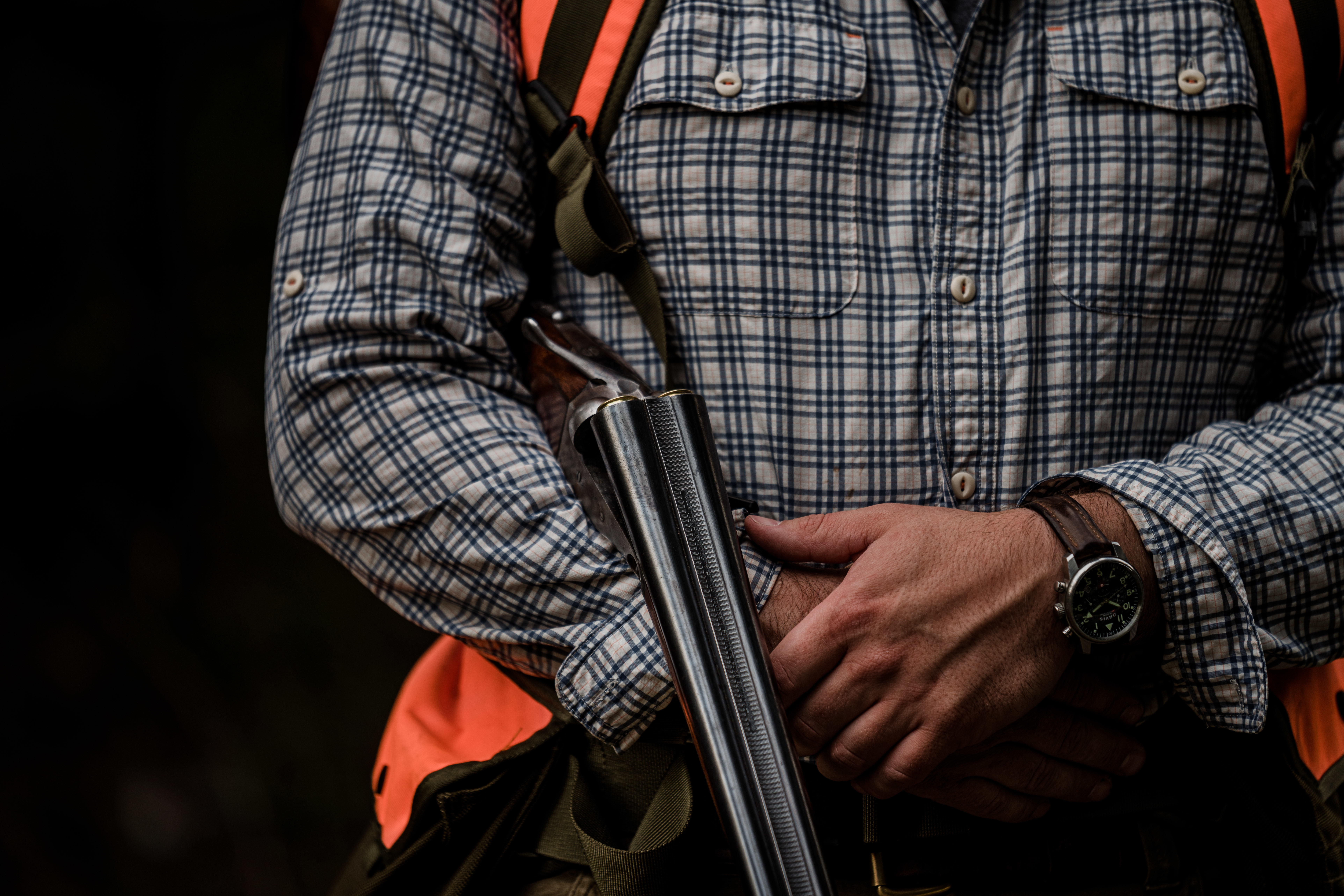 A hunter holds a side-by-side shotgun while grouse hunting in northwest Montana. A hunter holds a side-by-side shotgun while grouse hunting in northwest Montana.