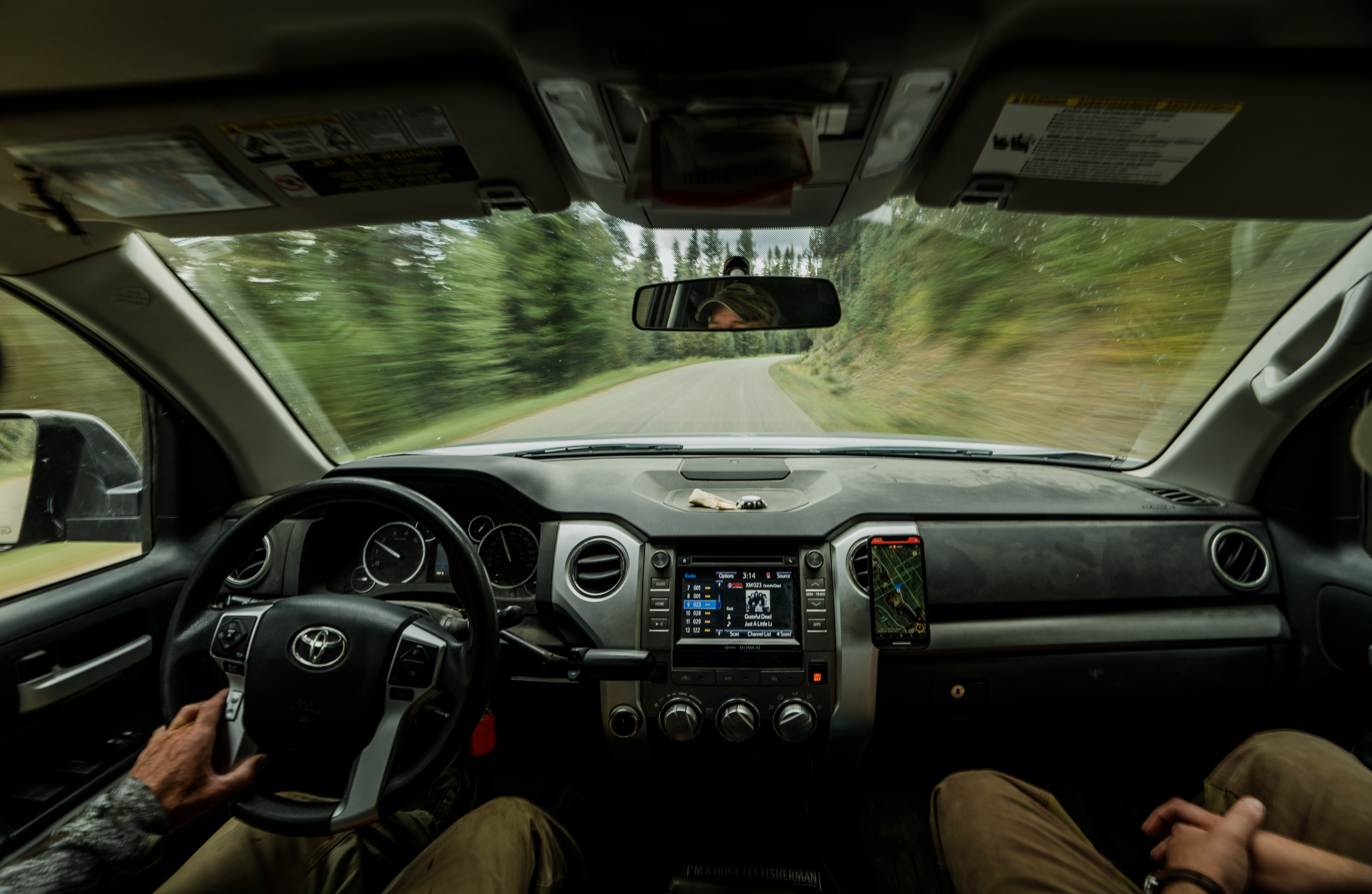 Two hunters ride in a truck while looking at the onX Hunt App. Two hunters ride in a truck while looking at the onX Hunt App.