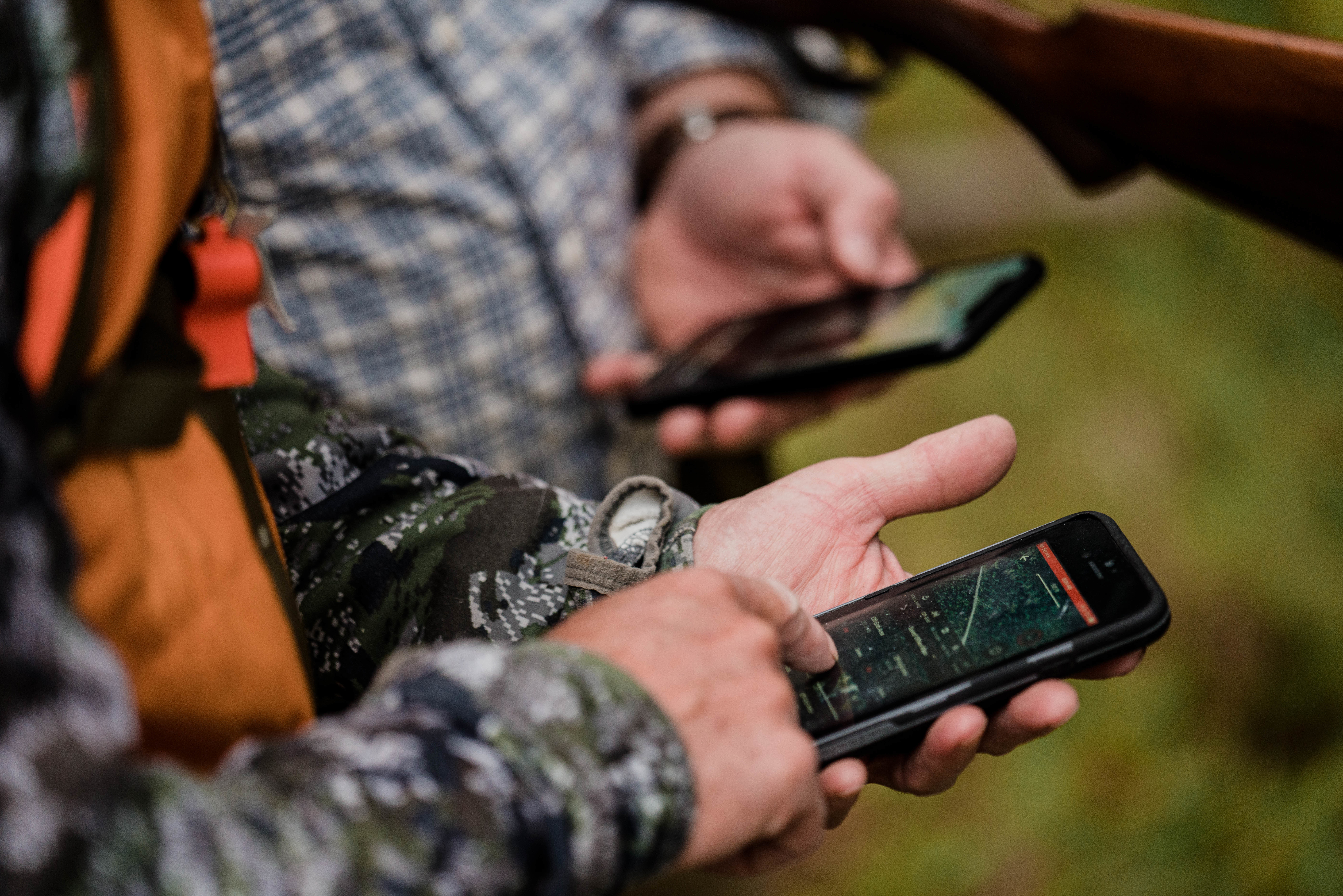 Two hunters use the onX Hunt App to decide which direction to go. Two hunters use the onX Hunt App to decide which direction to go.