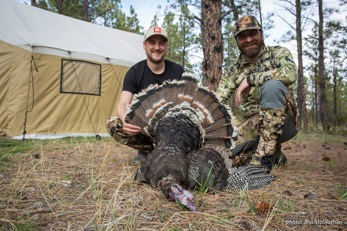Two hunters pose with a turkey they shot while hunting in Montana. Two hunters pose with a turkey they shot while hunting in Montana.