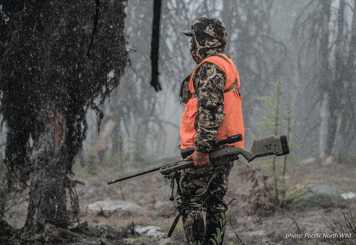 Man hunting in snow with rifle. Man hunting in snow with rifle.