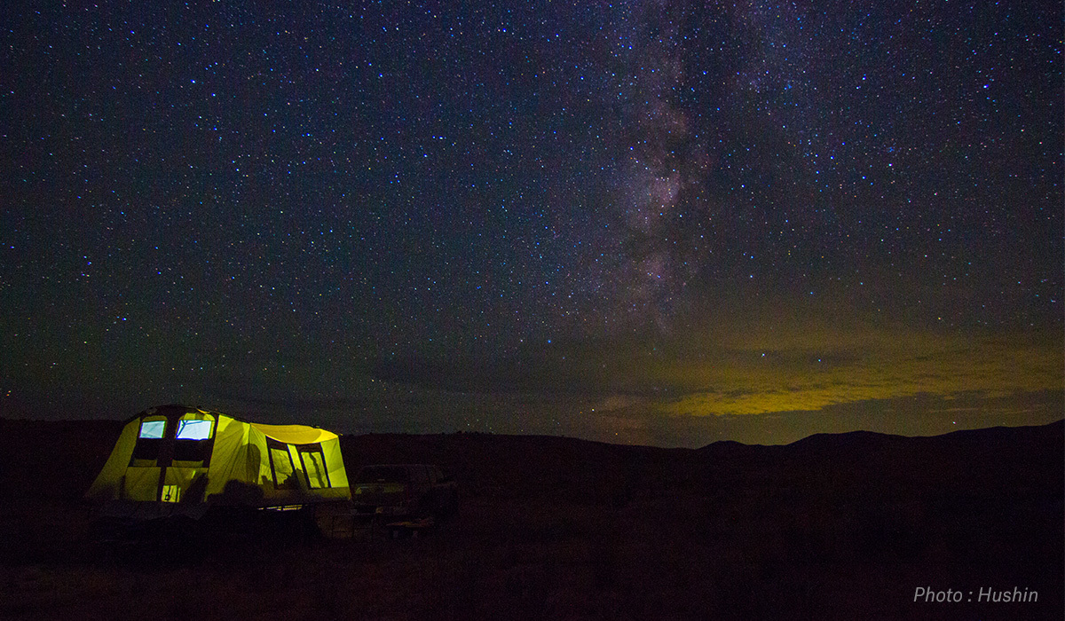 Summer nighttime photograph of tent with night sky. Summer nighttime photograph of tent with night sky.