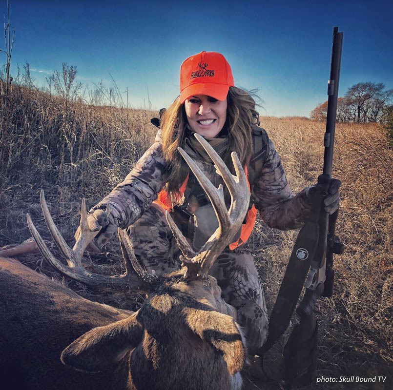 Woman hunter posing with deer shot during hunting season. Woman hunter posing with deer shot during hunting season.