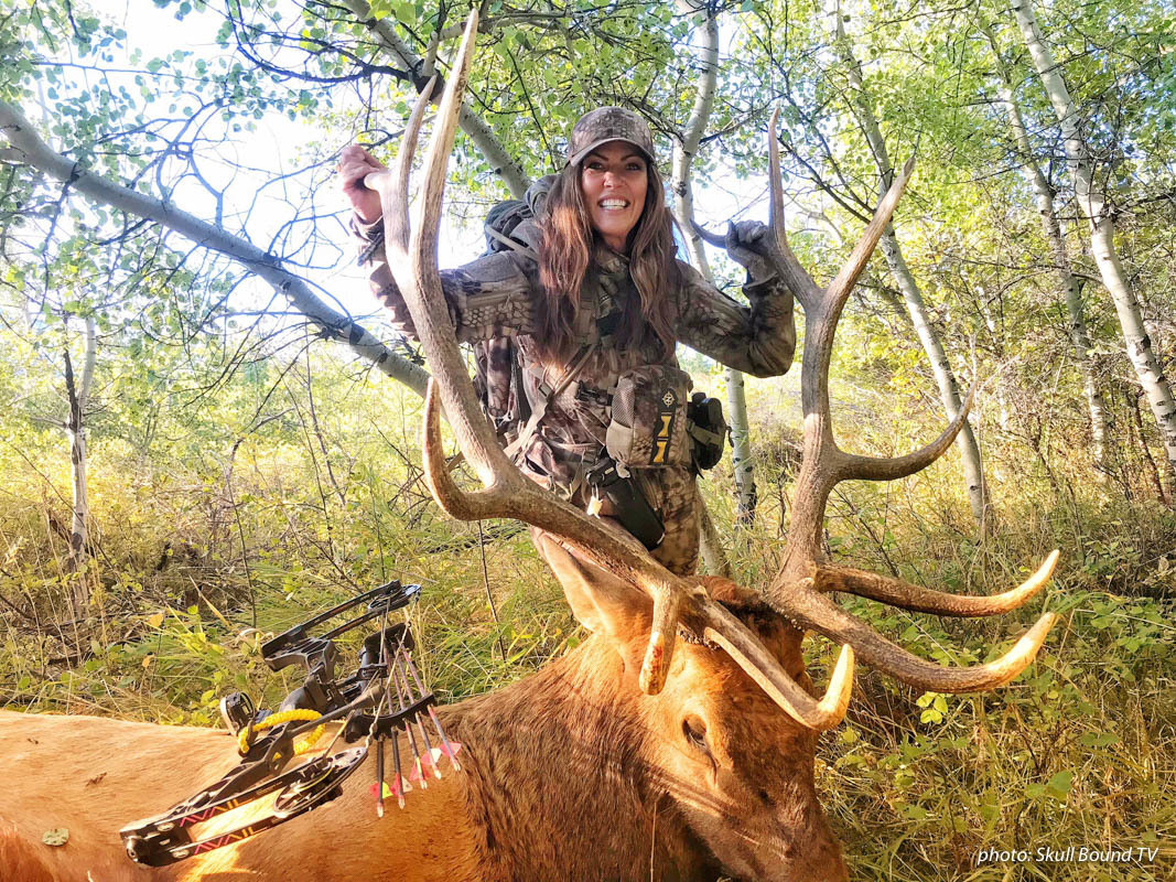 Women bowhunting with elk she shot. Women bowhunting with elk she shot.