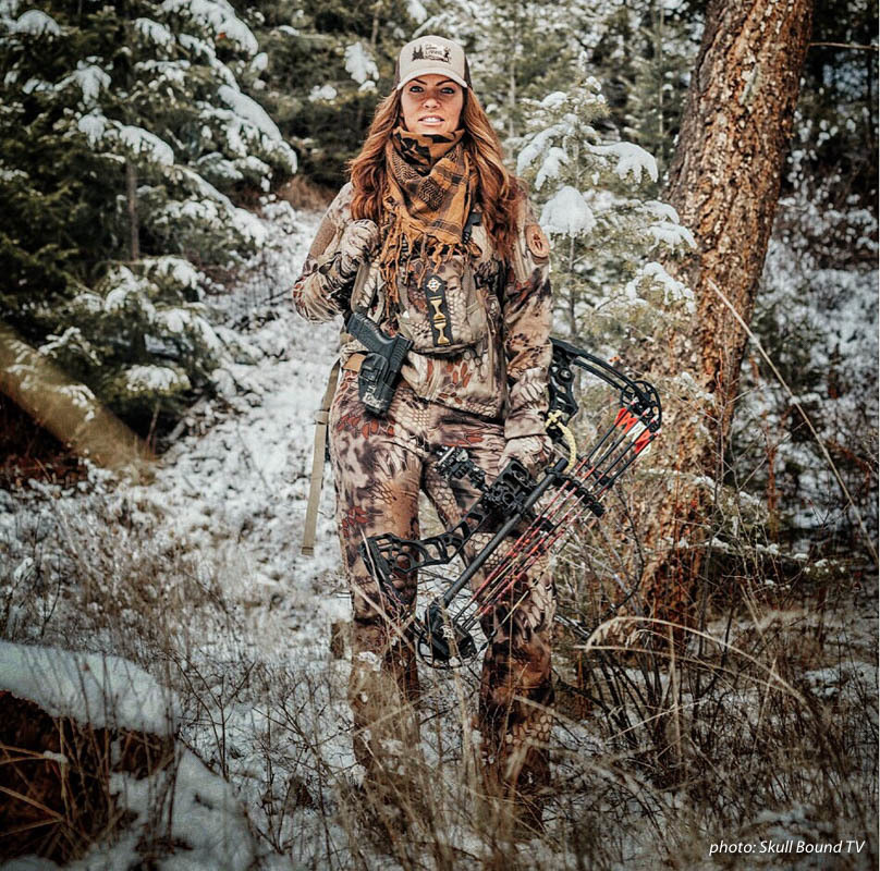 Woman in camouflage hunting in the snowy woods holding a compound bow. Woman in camouflage hunting in the snowy woods holding a compound bow.