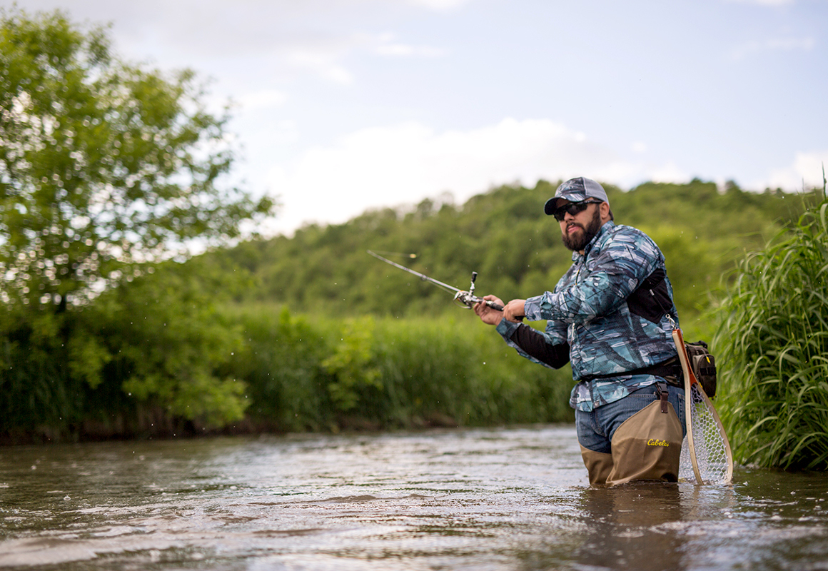 Fly fisherman using the onX Hunt app for finding river access Fly fisherman using the onX Hunt app for finding river access