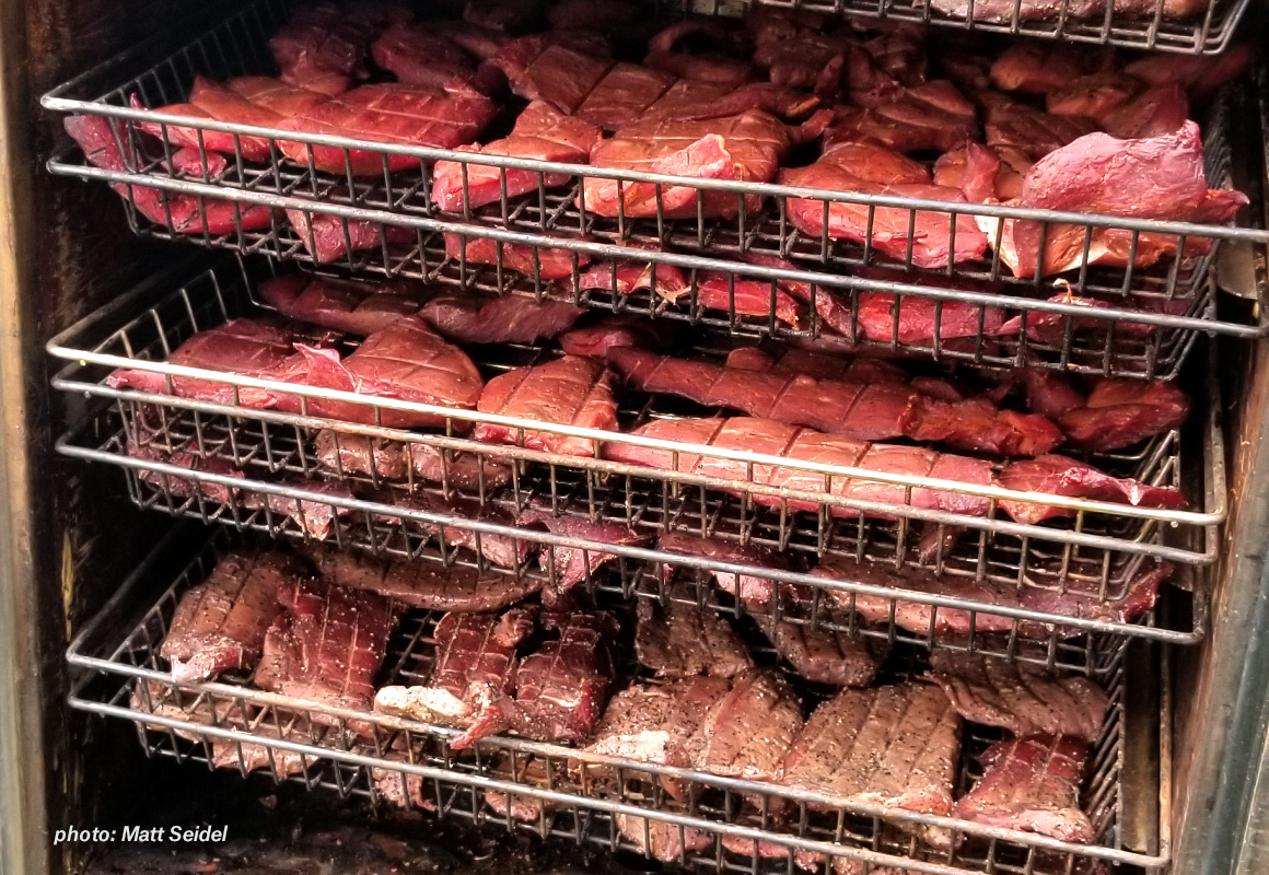 Meat in a large smoker. Meat in a large smoker.