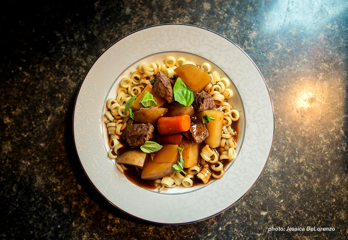 Image of wild game stew with pasta in a bowl on counter. Image of wild game stew with pasta in a bowl on counter.