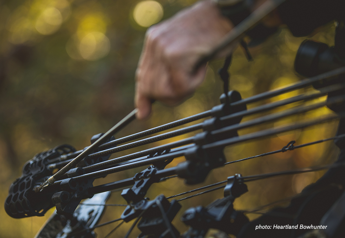 Hand holding a compound bow while hunting for whitetail. Hand holding a compound bow while hunting for whitetail.
